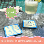 A drink with a lime wedge rests on the “You Drinking?” coaster by Drinks On Me, featuring humorous bail money text. Another matching coaster is nearby. 4x4 size fits all glasses—perfect for housewarmings or bar carts.